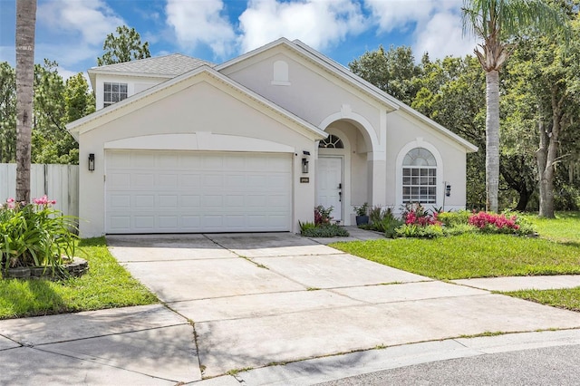 3706 Andover Cay Blvd, Orlando, FL 32825 - view of front of property with stucco siding, a garage, and driveway