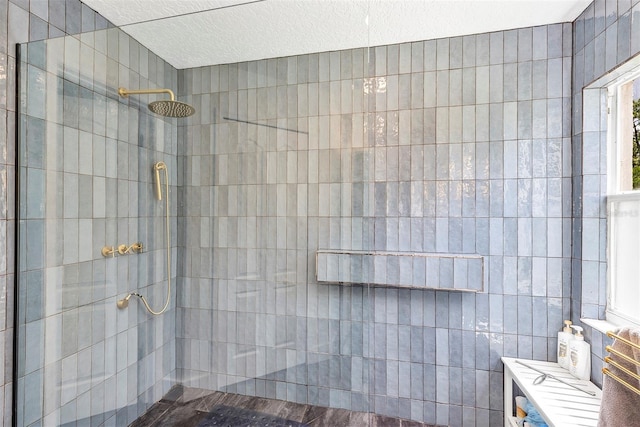 3706 Andover Cay Blvd, Orlando, FL 32825 - full bathroom with walk in shower, a textured ceiling, and tile walls