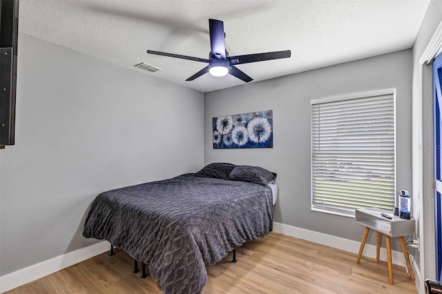 3706 Andover Cay Blvd, Orlando, FL 32825 - bedroom featuring wood finished floors, ceiling fan, and a textured ceiling