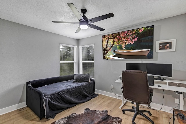 3706 Andover Cay Blvd, Orlando, FL 32825 - bedroom featuring a desk, wood finished floors, a textured ceiling, and ceiling fan