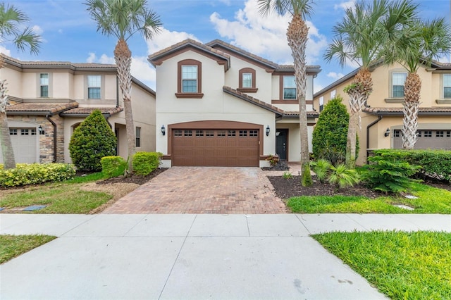 8912 Rhodes St, Kissimmee, FL 34747 - view of front of property with decorative driveway, stucco siding, a garage, and a tiled roof
