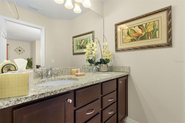 8912 Rhodes St, Kissimmee, FL 34747 - bathroom featuring double vanity and a chandelier
