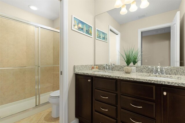 8912 Rhodes St, Kissimmee, FL 34747 - bathroom featuring double vanity, a stall shower, tile patterned flooring, and a chandelier