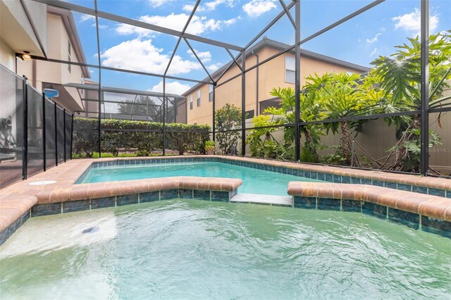 8912 Rhodes St, Kissimmee, FL 34747 - view of pool featuring a pool with connected hot tub and a lanai