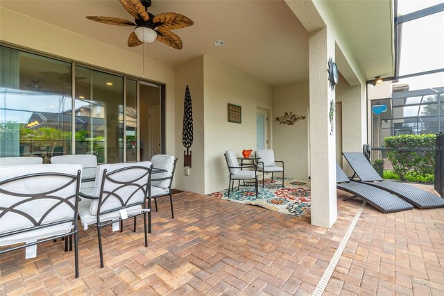 8912 Rhodes St, Kissimmee, FL 34747 - view of patio featuring a lanai, ceiling fan, and outdoor dining space