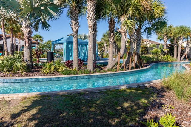 8912 Rhodes St, Kissimmee, FL 34747 - outdoor pool with a gazebo and a lawn