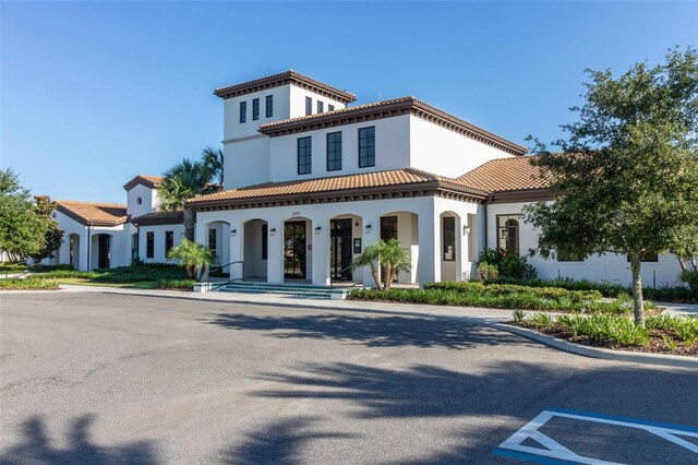 8912 Rhodes St, Kissimmee, FL 34747 - view of front facade with covered porch, stucco siding, and a tile roof