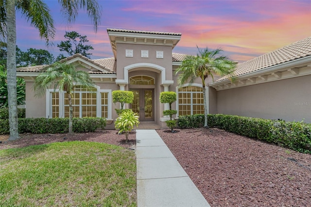 336 Highcroft Ct, Lake Mary, FL 32746 - doorway to property featuring french doors, a tile roof, stucco siding, and a yard