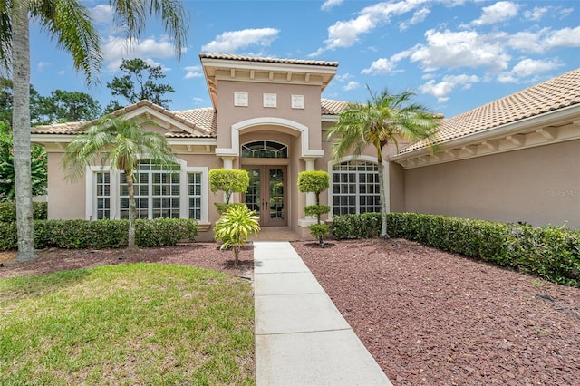 336 Highcroft Ct, Lake Mary, FL 32746 - property entrance with french doors, stucco siding, a tile roof, and a yard