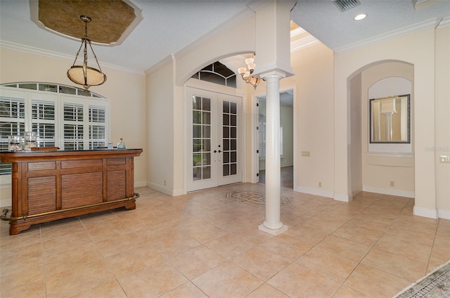 336 Highcroft Ct, Lake Mary, FL 32746 - dining space featuring french doors, arched walkways, ornamental molding, decorative columns, and light tile patterned flooring