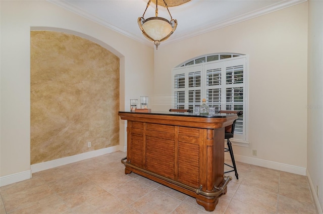 336 Highcroft Ct, Lake Mary, FL 32746 - indoor dry bar featuring crown molding, light tile patterned floors, arched walkways, and decorative light fixtures
