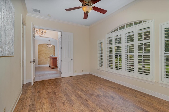 336 Highcroft Ct, Lake Mary, FL 32746 - empty room with crown molding, ceiling fan, wood finished floors, and a chandelier
