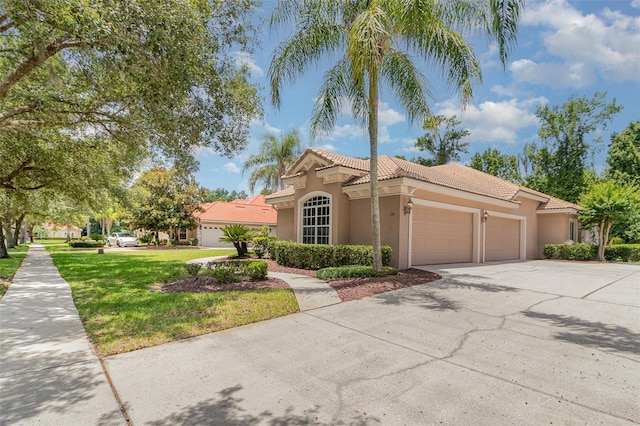 336 Highcroft Ct, Lake Mary, FL 32746 - mediterranean / spanish home with a garage, stucco siding, a tile roof, driveway, and a front lawn