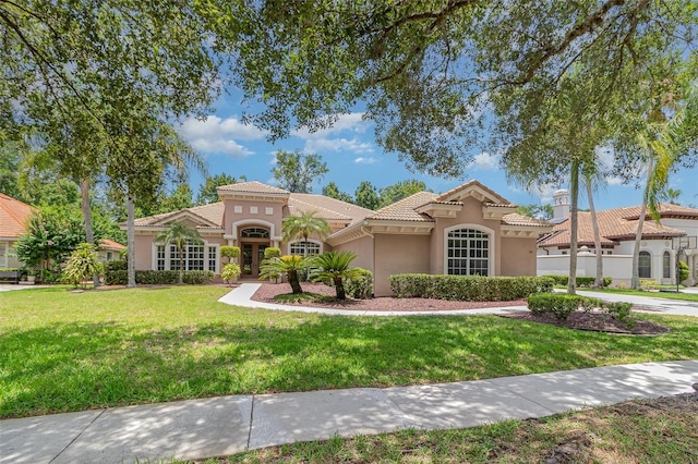 336 Highcroft Ct, Lake Mary, FL 32746 - mediterranean / spanish-style house with stucco siding, a front lawn, and a tile roof