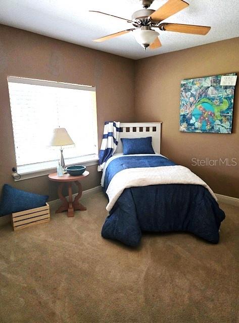 336 Highcroft Ct, Lake Mary, FL 32746 - carpeted bedroom with baseboards and a ceiling fan