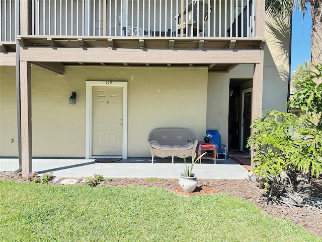 249 Afton Sq Unit 112, Altamonte Springs, FL 32714 - property entrance with a balcony, stucco siding, and a patio area
