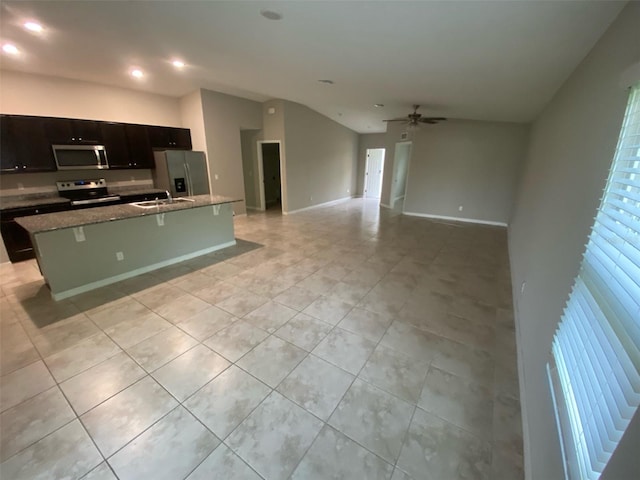 180 Ferguson St SE, Palm Bay, FL 32909 - kitchen featuring appliances with stainless steel finishes, light tile patterned flooring, an island with sink, recessed lighting, and lofted ceiling