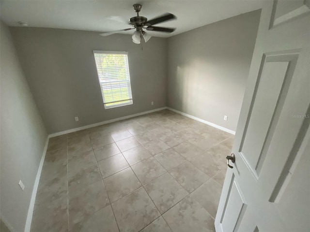 180 Ferguson St SE, Palm Bay, FL 32909 - empty room with a ceiling fan and light tile patterned flooring