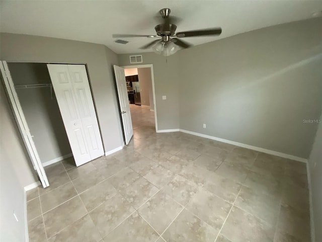 180 Ferguson St SE, Palm Bay, FL 32909 - unfurnished bedroom with light tile patterned flooring, a closet, and a ceiling fan