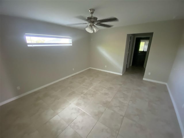 180 Ferguson St SE, Palm Bay, FL 32909 - empty room featuring a ceiling fan and light tile patterned floors