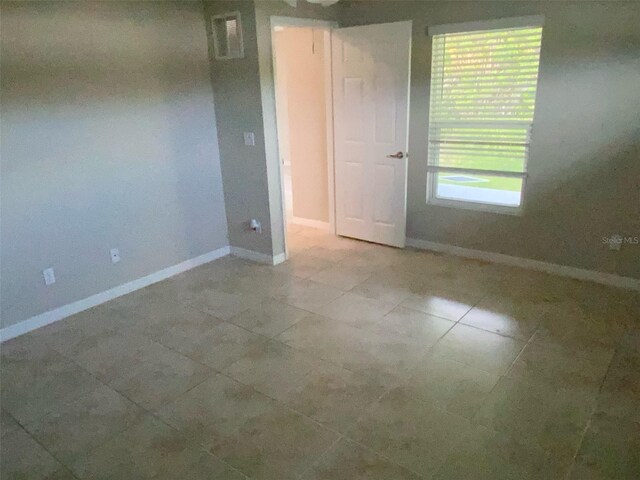 180 Ferguson St SE, Palm Bay, FL 32909 - spare room with tile patterned flooring and baseboards