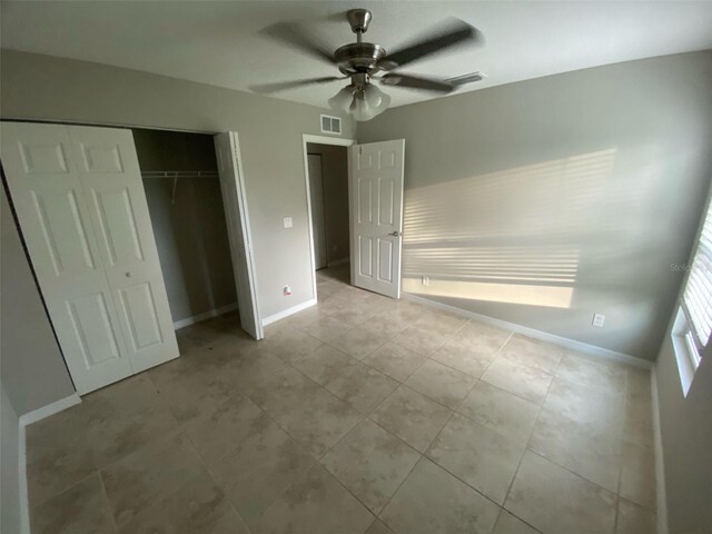 180 Ferguson St SE, Palm Bay, FL 32909 - unfurnished bedroom featuring a closet, light tile patterned floors, and a ceiling fan