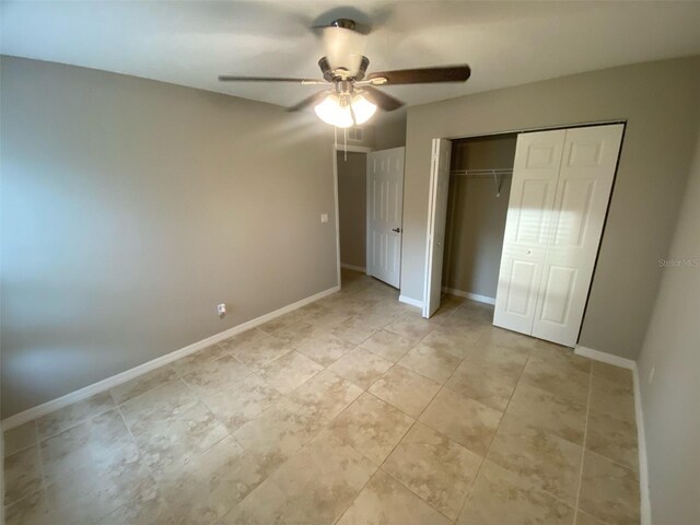 180 Ferguson St SE, Palm Bay, FL 32909 - unfurnished bedroom with a closet, a ceiling fan, and light tile patterned flooring