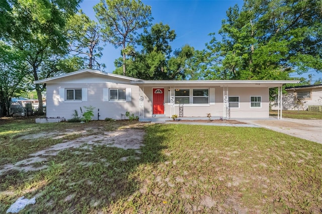 5908 Laconia Rd, Orlando, FL 32808 - ranch-style house featuring a front yard, driveway, and a porch