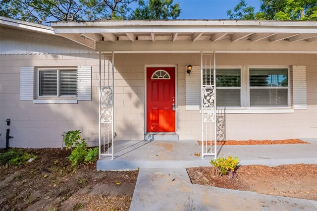 5908 Laconia Rd, Orlando, FL 32808 - view of exterior entry with concrete block siding and a porch