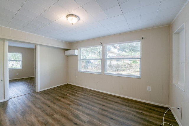 5908 Laconia Rd, Orlando, FL 32808 - empty room with a wall unit AC and dark wood finished floors
