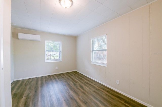 5908 Laconia Rd, Orlando, FL 32808 - spare room with an AC wall unit and dark wood finished floors