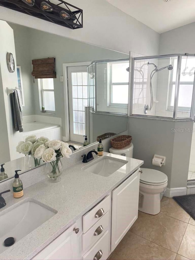 2650 Autumn Creek Cir, Kissimmee, FL 34747 - full bath featuring a stall shower, tile patterned floors, and double vanity