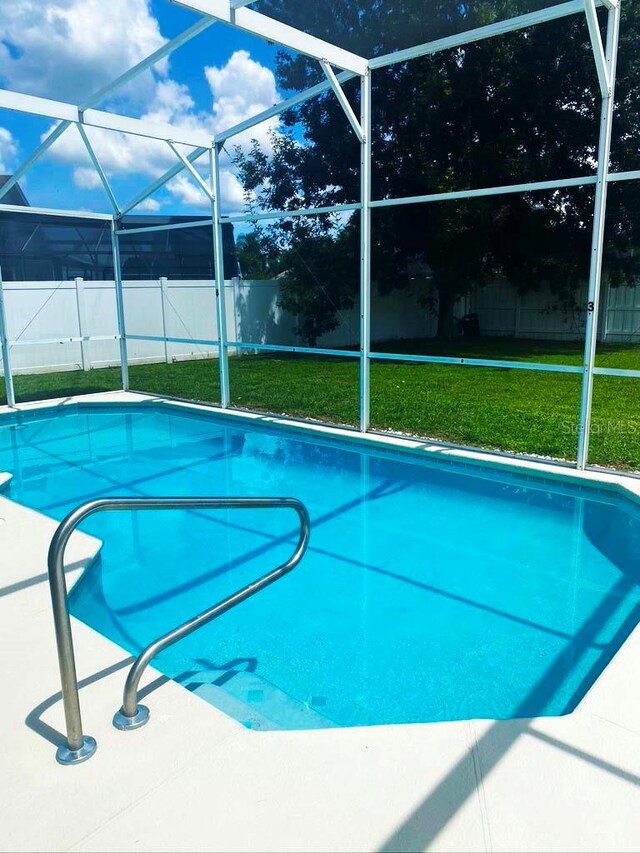 2650 Autumn Creek Cir, Kissimmee, FL 34747 - view of swimming pool featuring a fenced backyard and glass enclosure