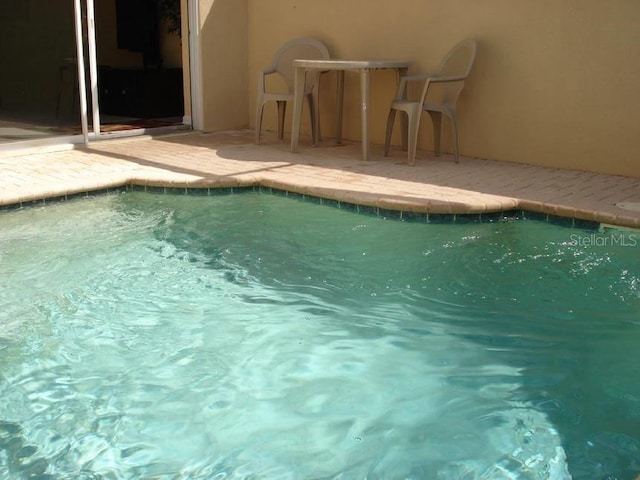 7682 Sir Kaufmann Ct, Kissimmee, FL 34747 - swimming pool featuring a patio area