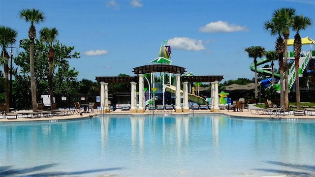 7682 Sir Kaufmann Ct, Kissimmee, FL 34747 - community pool featuring a pergola and a patio area