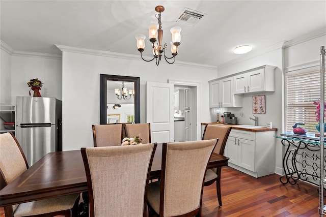 2312 S Summerlin Ave, Orlando, FL 32806 - dining room with a chandelier, ornamental molding, and dark wood finished floors