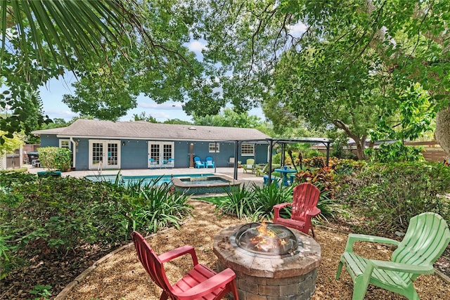 2312 S Summerlin Ave, Orlando, FL 32806 - rear view of house with french doors, a fire pit, a patio, an outdoor pool, and an in-ground hot tub
