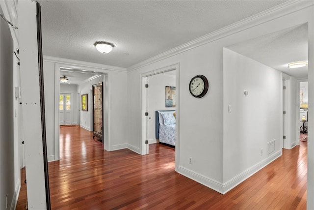 2312 S Summerlin Ave, Orlando, FL 32806 - corridor with hardwood / wood-style flooring, ornamental molding, and a textured ceiling