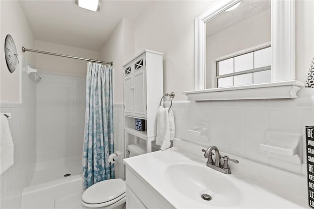 2312 S Summerlin Ave, Orlando, FL 32806 - full bathroom with vanity, tiled shower, tile walls, and wainscoting