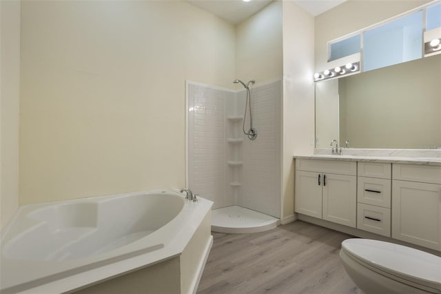 1065 Universal Rest Pl, Kissimmee, FL 34744 - bathroom with a garden tub, wood finished floors, double vanity, and a tile shower