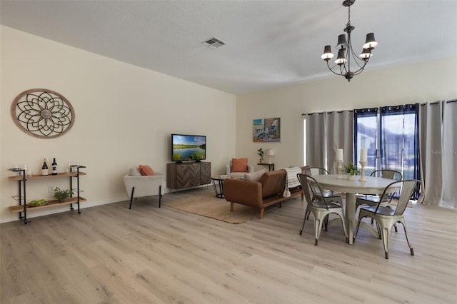 1065 Universal Rest Pl, Kissimmee, FL 34744 - dining area with a chandelier and light wood-style floors
