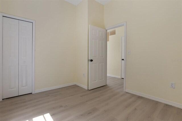1065 Universal Rest Pl, Kissimmee, FL 34744 - unfurnished bedroom with light wood finished floors and a closet