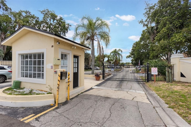 1065 Universal Rest Pl, Kissimmee, FL 34744 - view of asphalt road with a gate and a gated entry
