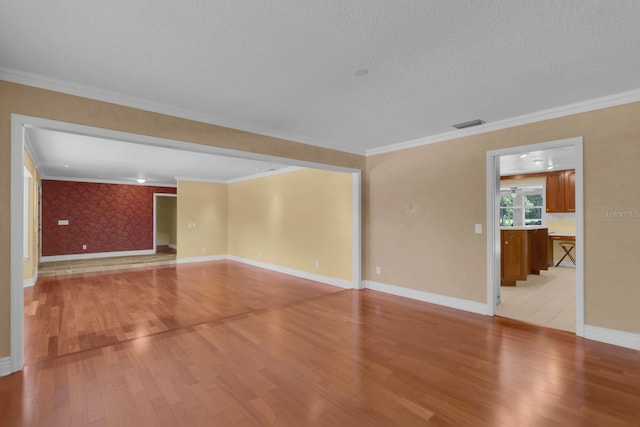 202 Riverview Dr, Longwood, FL 32779 - unfurnished room featuring light wood-style floors, ornamental molding, and a textured ceiling