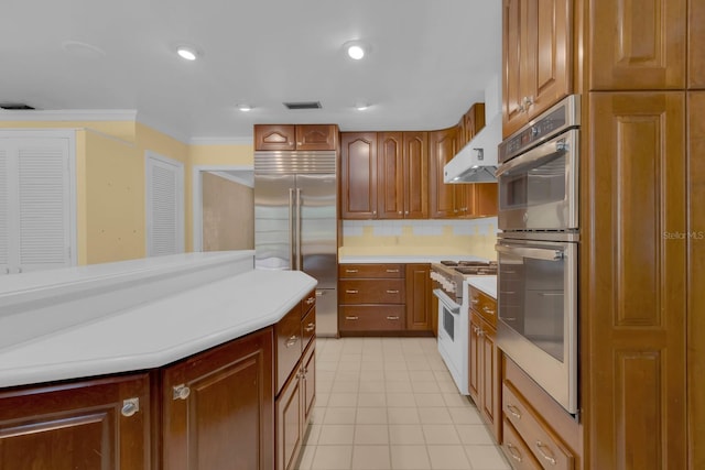 202 Riverview Dr, Longwood, FL 32779 - kitchen featuring high quality appliances, light countertops, light tile patterned floors, ornamental molding, and tasteful backsplash