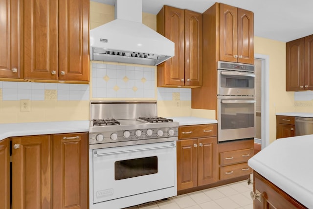 202 Riverview Dr, Longwood, FL 32779 - kitchen featuring appliances with stainless steel finishes, range hood, light countertops, backsplash, and brown cabinets