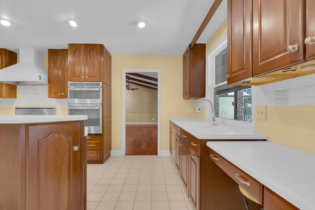 202 Riverview Dr, Longwood, FL 32779 - kitchen with wall chimney range hood, double oven, backsplash, light countertops, and brown cabinetry