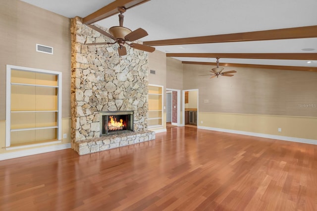 202 Riverview Dr, Longwood, FL 32779 - unfurnished living room featuring a ceiling fan, beam ceiling, a stone fireplace, wood finished floors, and high vaulted ceiling