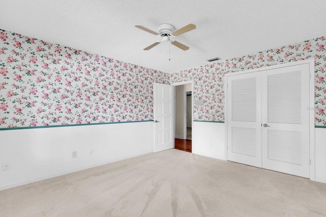 202 Riverview Dr, Longwood, FL 32779 - unfurnished bedroom featuring wallpapered walls, carpet, a closet, and ceiling fan