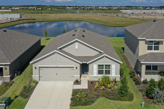 17127 Harvest Moon Way, Bradenton, FL 34211 - view of front facade featuring stone siding, a garage, a water view, and stucco siding